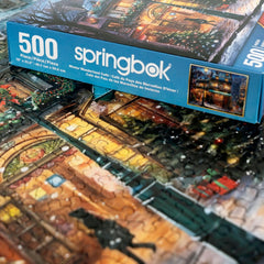 Springbok puzzle artwork highlights wreaths and garlands on a joyful holiday storefront.
