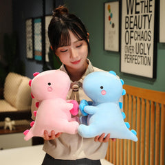 SQEQE dino plush sits neatly on a desk as a decor accent
