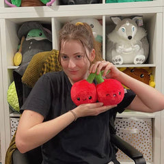 Squishable Snugglemi Snacker Cherries resting on a shelf for cozy decor