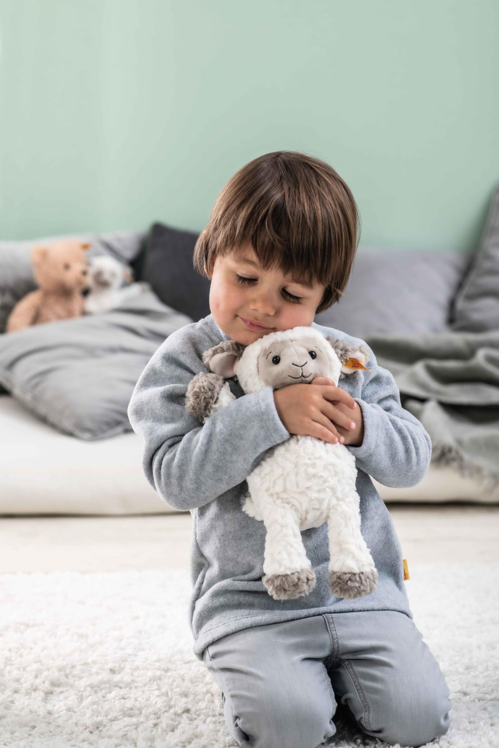Steiff Lita Lamb embroidered face detail for gentle, expressive play.