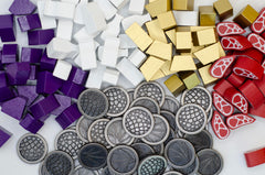 Stonemaier Wyrmspan metal coins close-up highlighting dragon motifs and shine