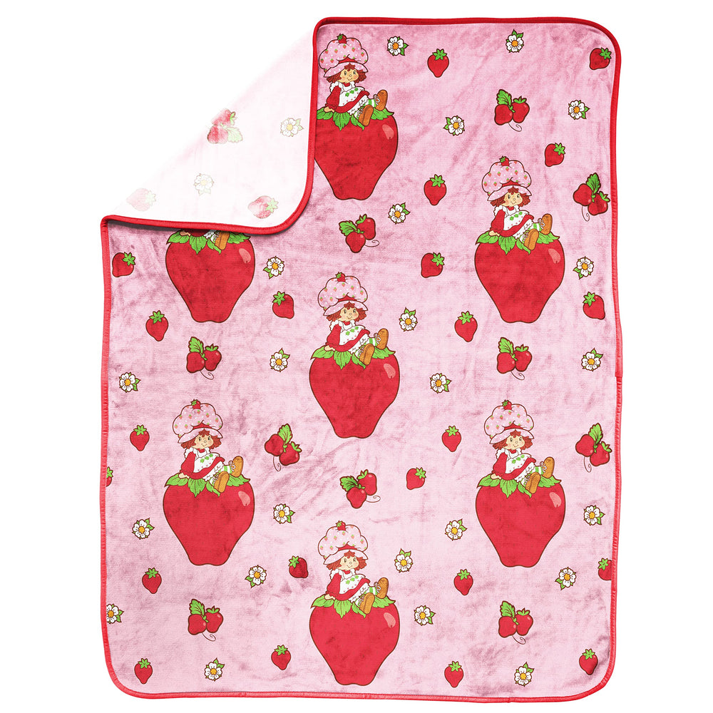 Strawberry Shortcake soft-fleece blanket close-up highlights plush texture