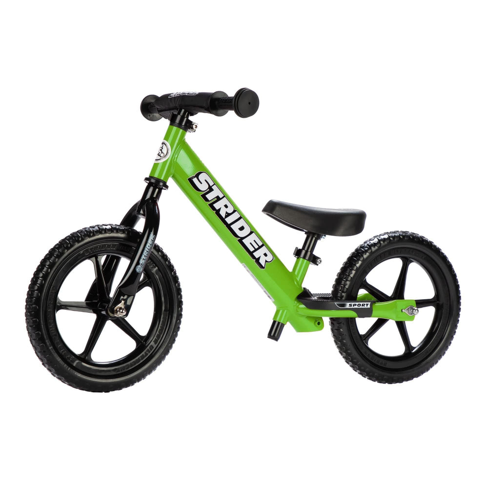 Strider 12-inch Sport Bike green side view highlighting balance-friendly design for beginners.