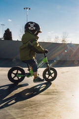Strider child riding balance bike to illustrate early balance practice.
