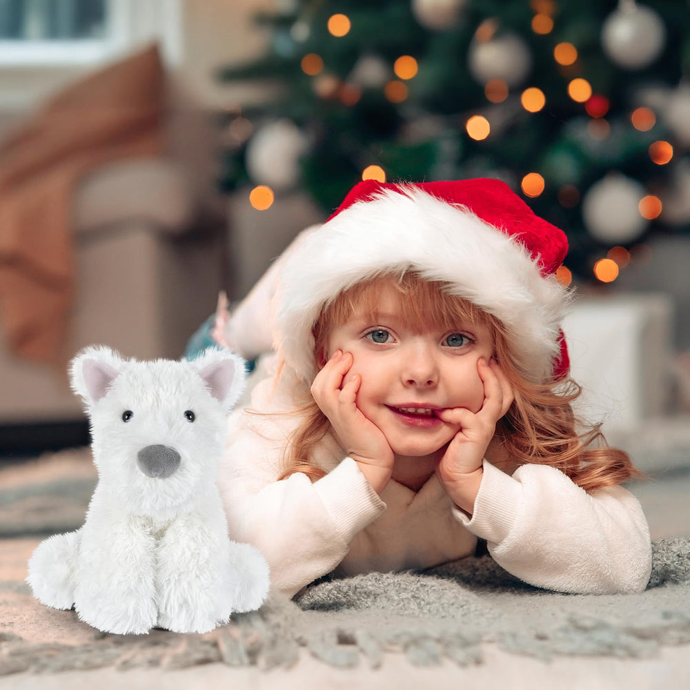 Child hugs SuzziPals Westie plush for comfort