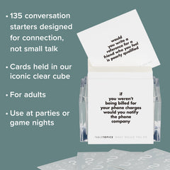 TableTopics party game on table prompts lively discussion among friends.