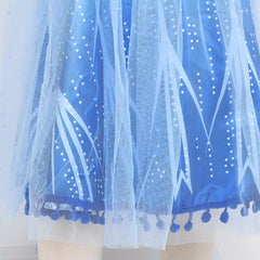 Tacobear pom-pom hem blue dress detail adds playful charm.