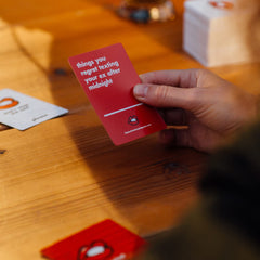 White phrase cards from That's What She Said offer varied prompts for laughs