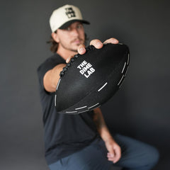 The Dime Lab Water Football closeup grip highlighting silicone grip strips for wet handling.