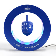The Dreidel Company Hanukkah floating dreidel on a desk display for modern décor.