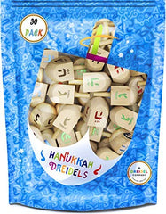 The Dreidel Company natural wood dreidel close-up with foil-embossed letters.