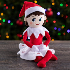 The Elf on the Shelf Plushee Pal Light being held by a child.