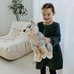 The Petting Zoo wolf plush tag and fabric emphasize eco-friendly construction.