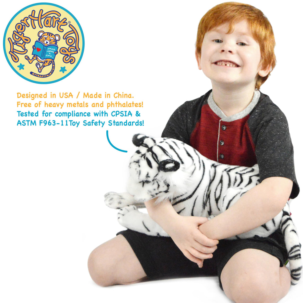 TigerHart Saphed White Tiger plush held by a child for comforting companionship.