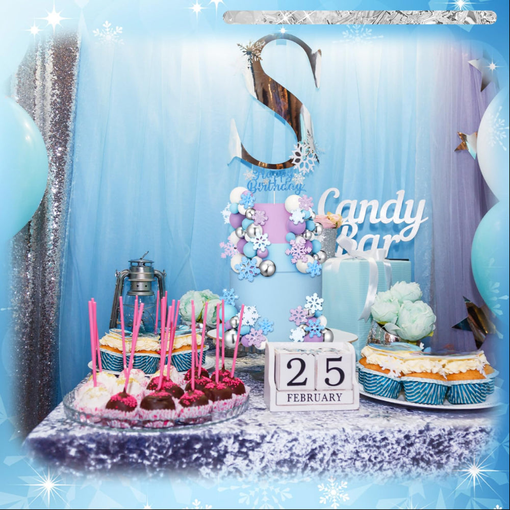 Tioncy varied sizes of snowflakes and balls help create a balanced cake display.