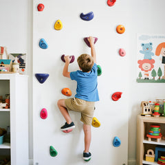 TOPNEW rock wall kit installed in an outdoor backyard playground.