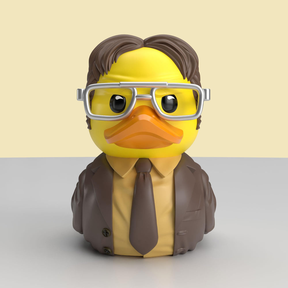 TUBBZ mini Dwight Schrute duck on a shelf, collectible desk companion.