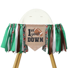 TUTOTU football 1st-year-down banner on a highchair for memorable birthday photos