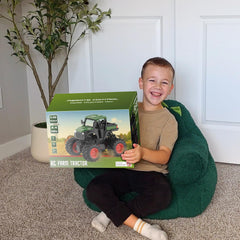 Uarzt 1:16 RC tractor side view shows rugged wheels suitable for indoor and outdoor use.