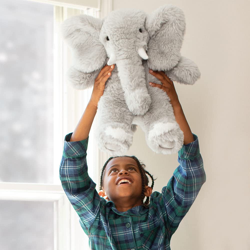 Gray elephant plush side view showing soft fur and friendly expression.