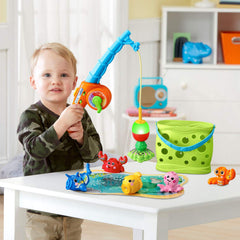 Interactive fishing pole guiding a magnetic catch above the mat