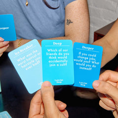 WHAT DO YOU MEME? Let’s Get Deep Ice Breaker cards on display sparking quick chats