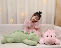 XMV dinosaur weighted plush in a cozy bedroom setup.