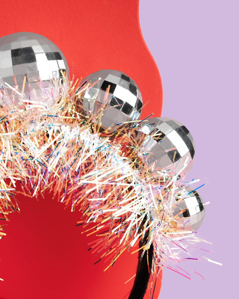 xo Fetti disco ball headband worn by an adult shows versatile sizing.