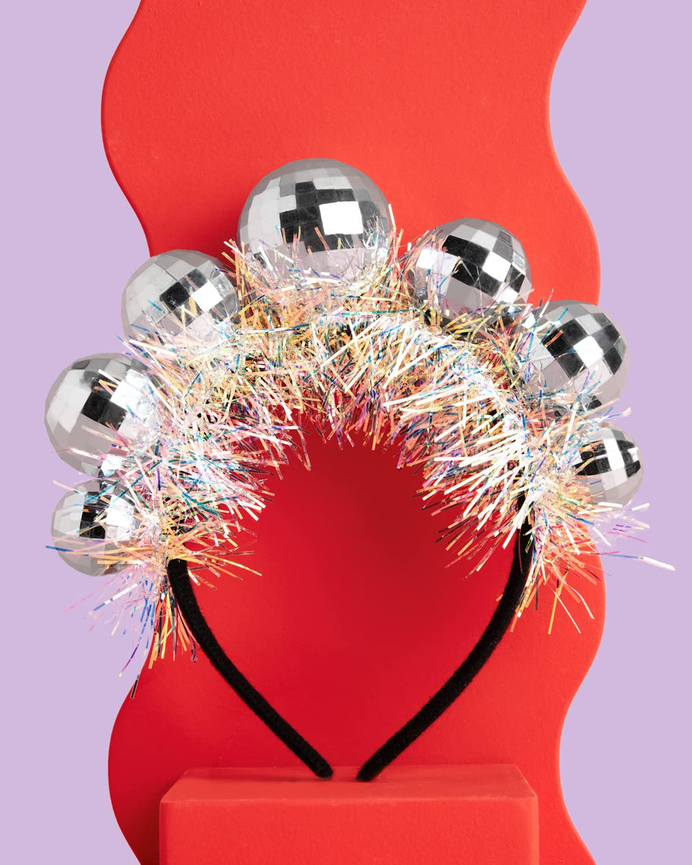 xo Fetti disco ball headband worn by a child highlights comfortable, adjustable fit.
