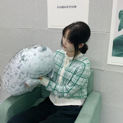 YESGIRL seal plush pillow fluffing reveals cloud-soft touch.