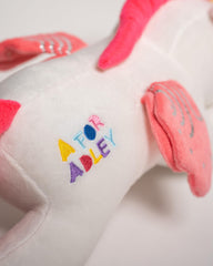 A FOR ADLEY unicorn features silvery wing accents, adding sparkle to playtime.