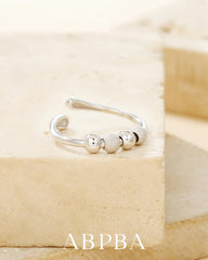 ABPBA ring stacked beside other rings for style