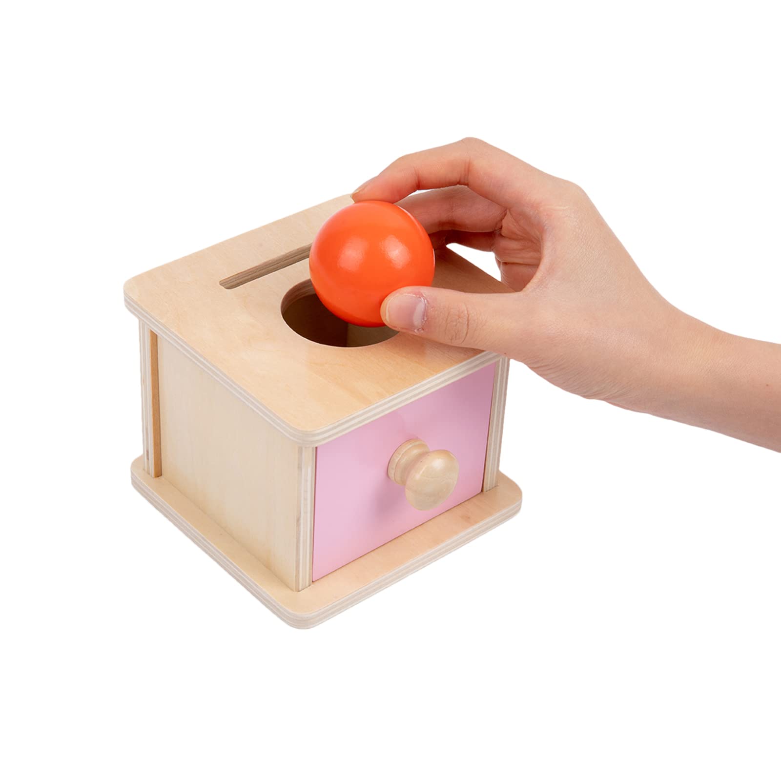 Adena Montessori coin box pink door design brightens nursery play spaces.