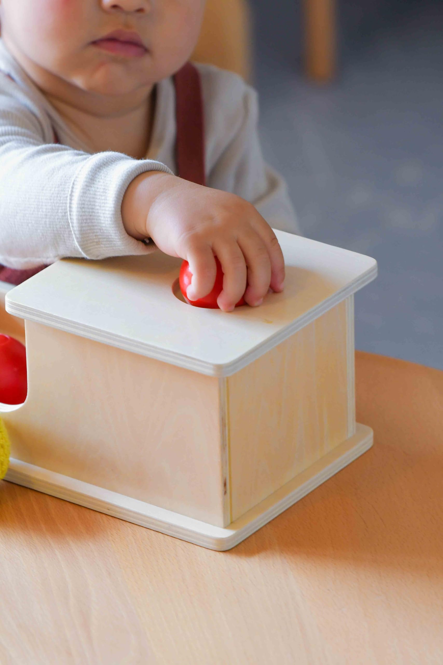 Adena Montessori wooden log-colored ball invites tactile exploration.