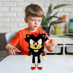 Adenzai Black Plush Toy resting by a pillow for bedtime routine