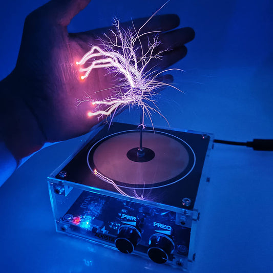 ALKISTA Tesla coil musical speaker front view with vibrant plasma arc on a compact desk
