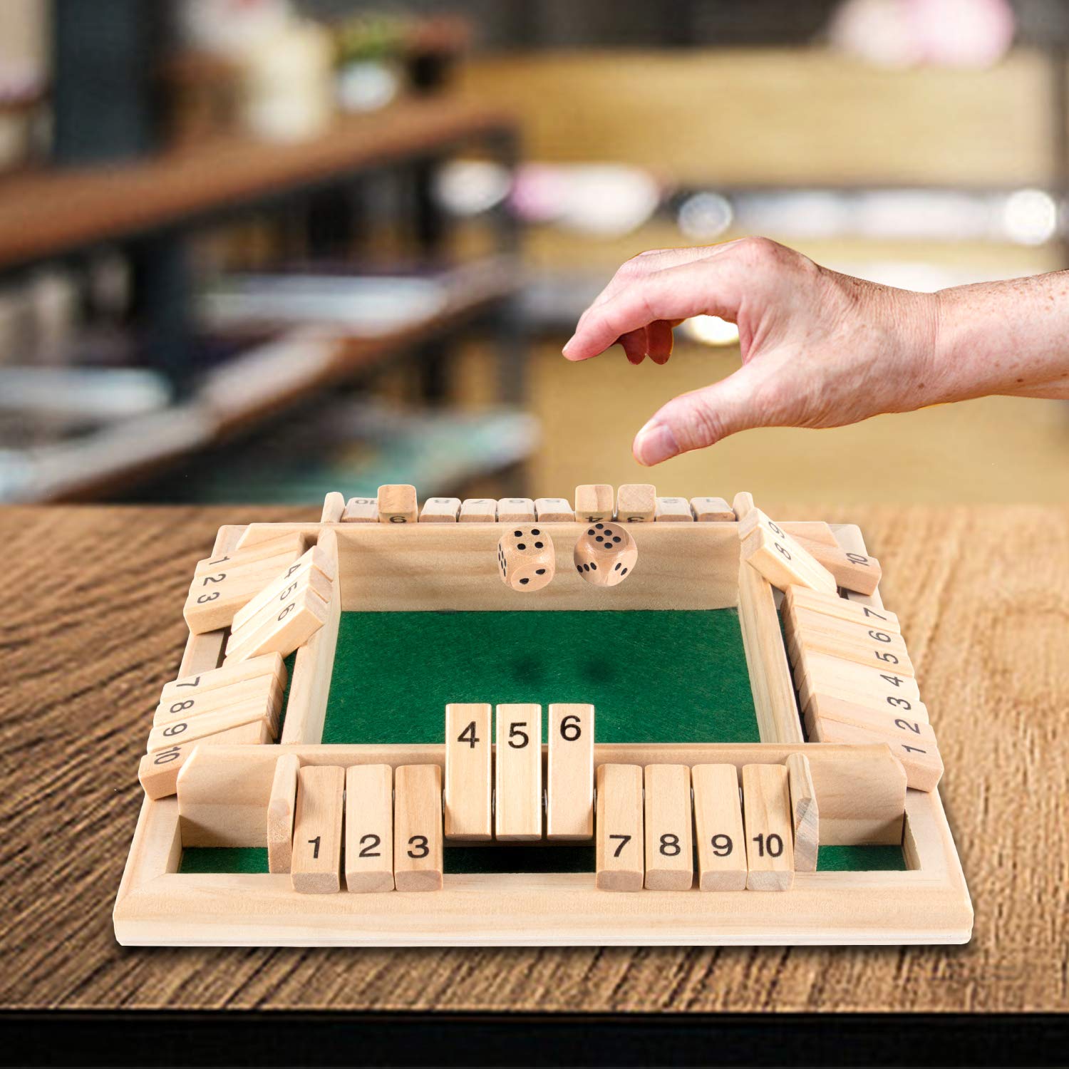 AMEROUS includes 10 dice and 10 numbered tiles for flexible play.