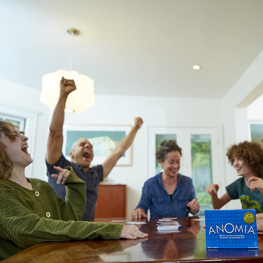 Anomia card game in action with friends laughing during quick, competitive rounds.