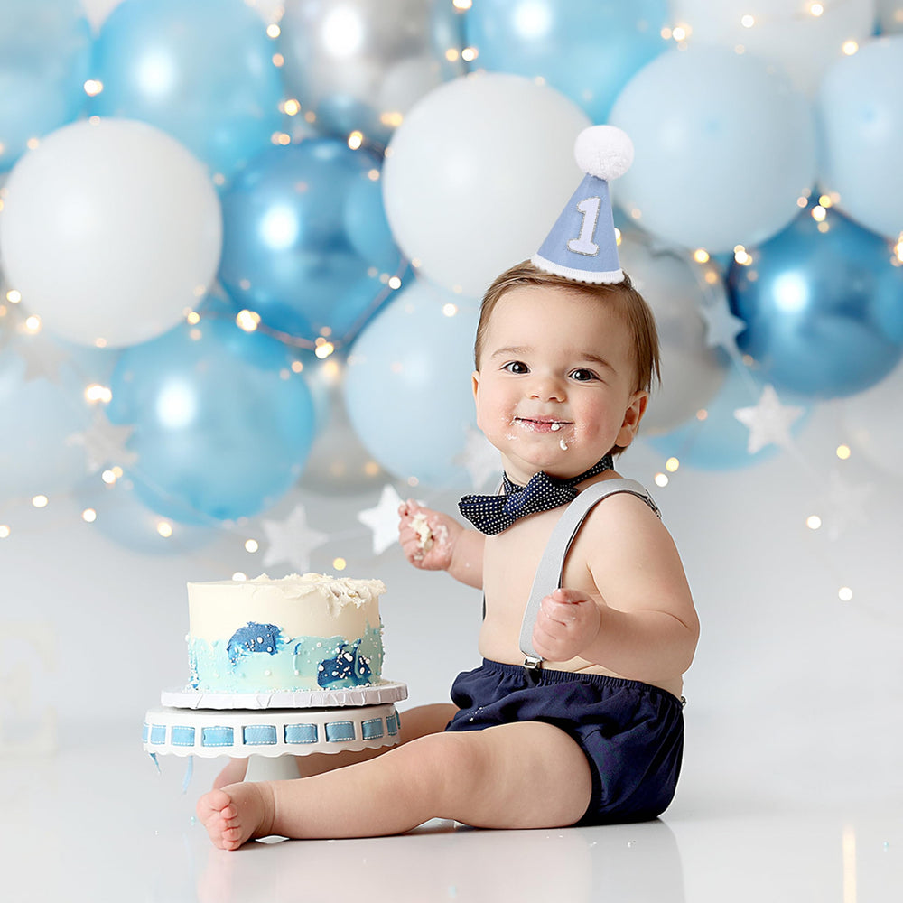 AOQURE first birthday crown with pom-poms close-up, rustic charm for keepsakes.