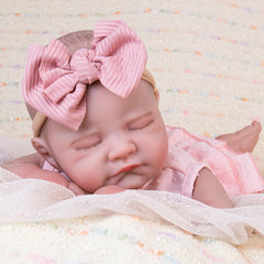 Aori Reborn Baby Doll with hair and eyelash detail enhances realism for display play.