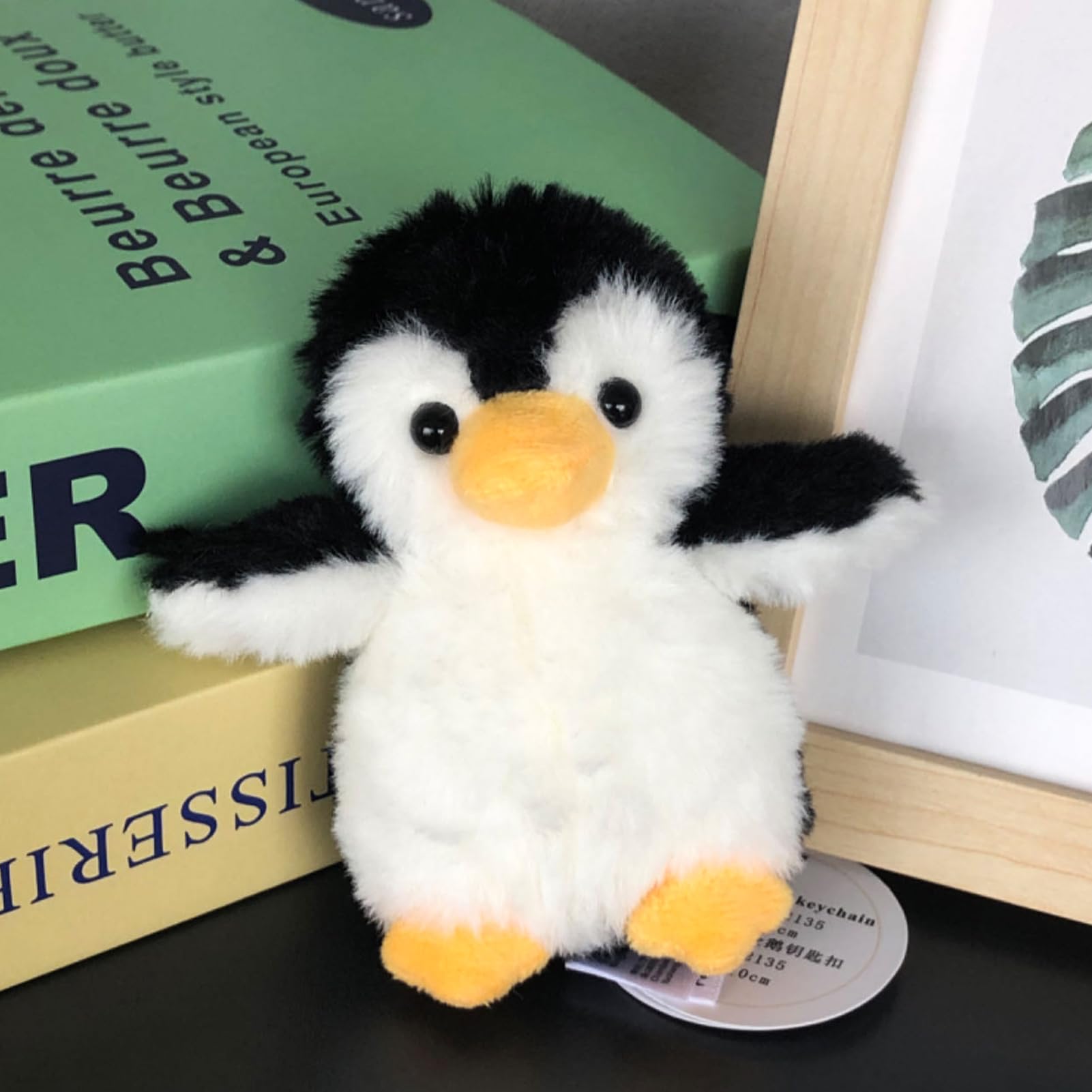 Apricot Lamb penguin keychain side view shows soft plush texture for daily use.