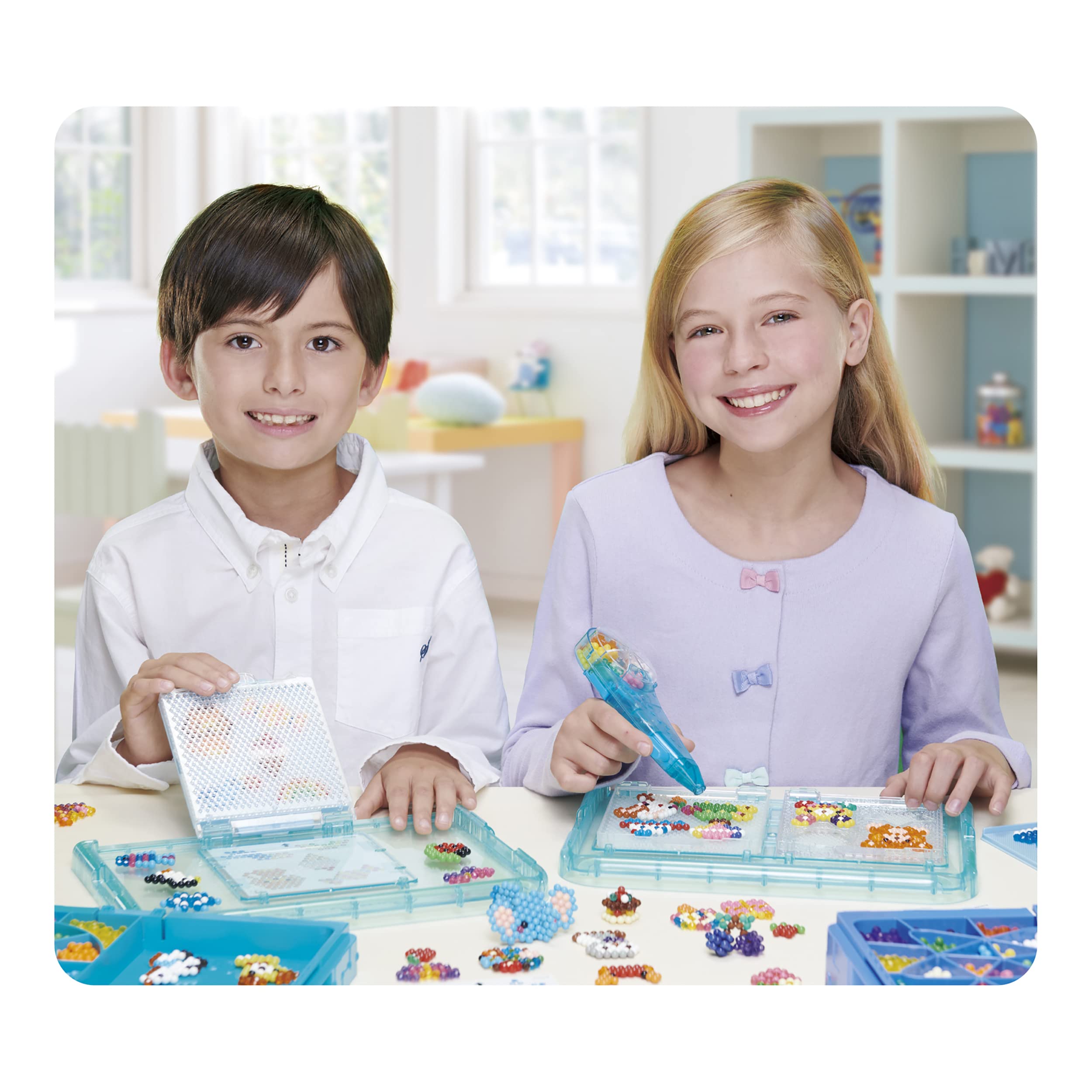 Aquabeads beads in child hands over a tray demonstrating safe supervised crafting