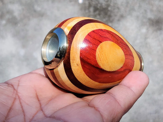 Arch Instruments egg shape kaleidoscope with wooden body showing evolving color patterns