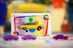 Asmodee Ticket to Ride New York taxi tokens close-up capturing urban vibe.