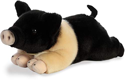 Aurora Miyoni Hampshire Pig plush in a cozy bedroom decor setup