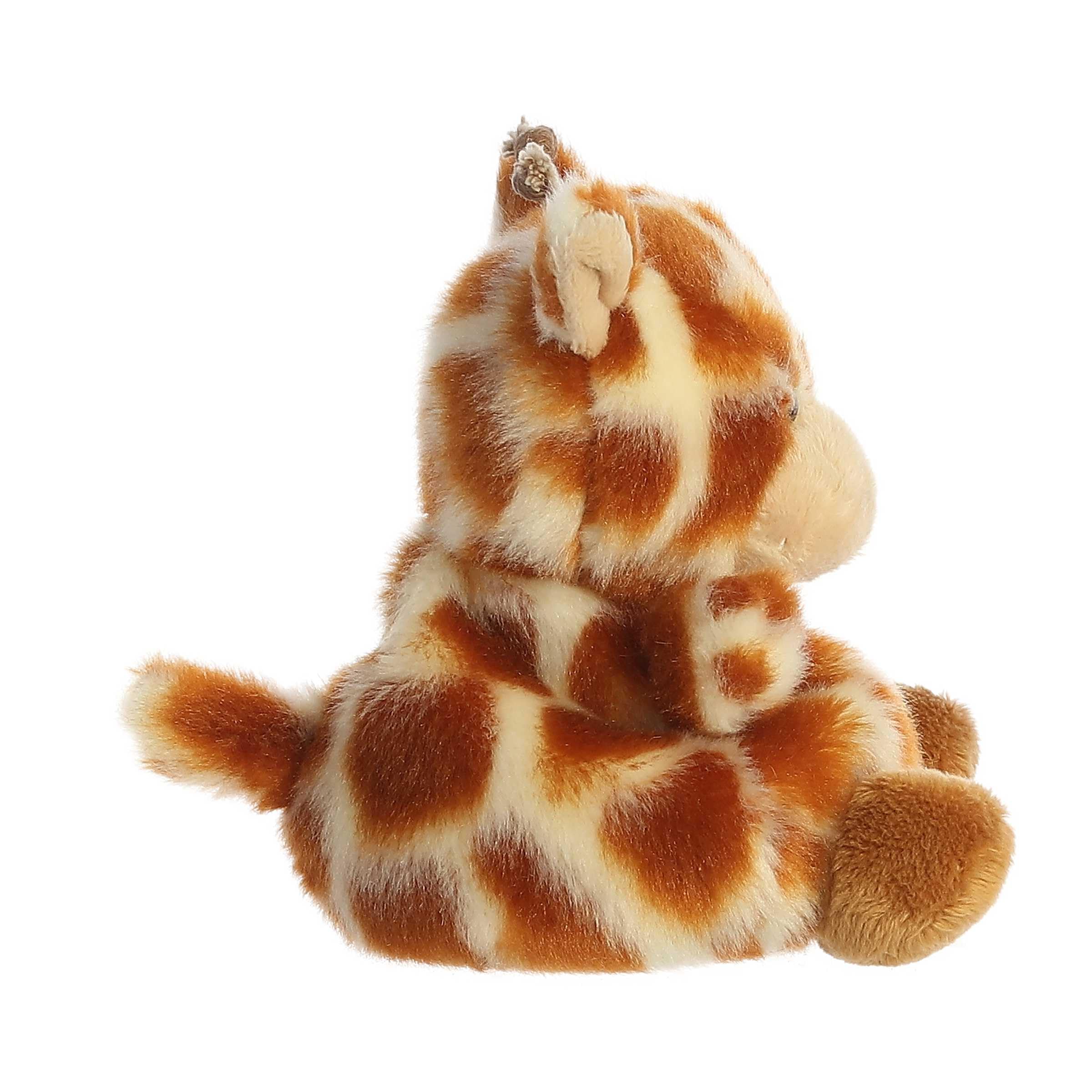 Safara Giraffe in hand demonstrates palm sized plush for easy holding