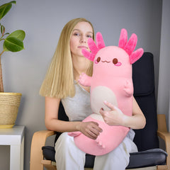 Auspicious Beginning axolotl pillow in bedroom scene as nap pillow.