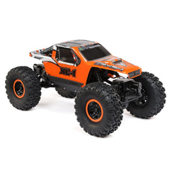 Axial AX24 XC-1 orange body stands out on shaded trails.