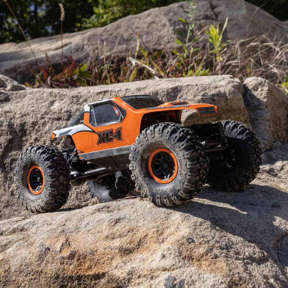 Axial AX24 XC-1 side profile with 4WS highlights precise control on uneven terrain.