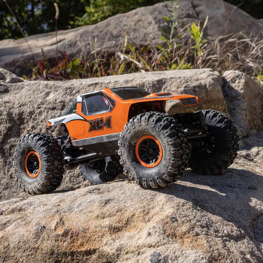 Axial AX24 XC-1 side profile with 4WS highlights precise control on uneven terrain.
